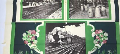 A close up of a poster showing images of milk churns at a station and a train. Green boarders and flowers surround the images. Along the fold lines of the poster are holes and tears.