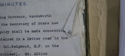 Tears and damage to the edges of pages in a tagged file, with the tear going through text on the front page.