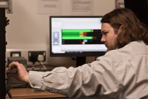 A trainee adjusting the dials at their digital workstation