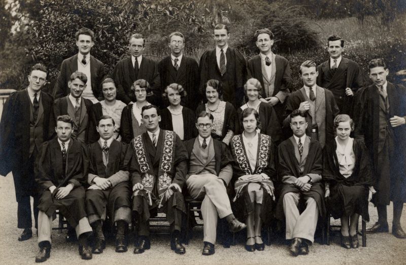 People in smart attire and gowns posed in three rows