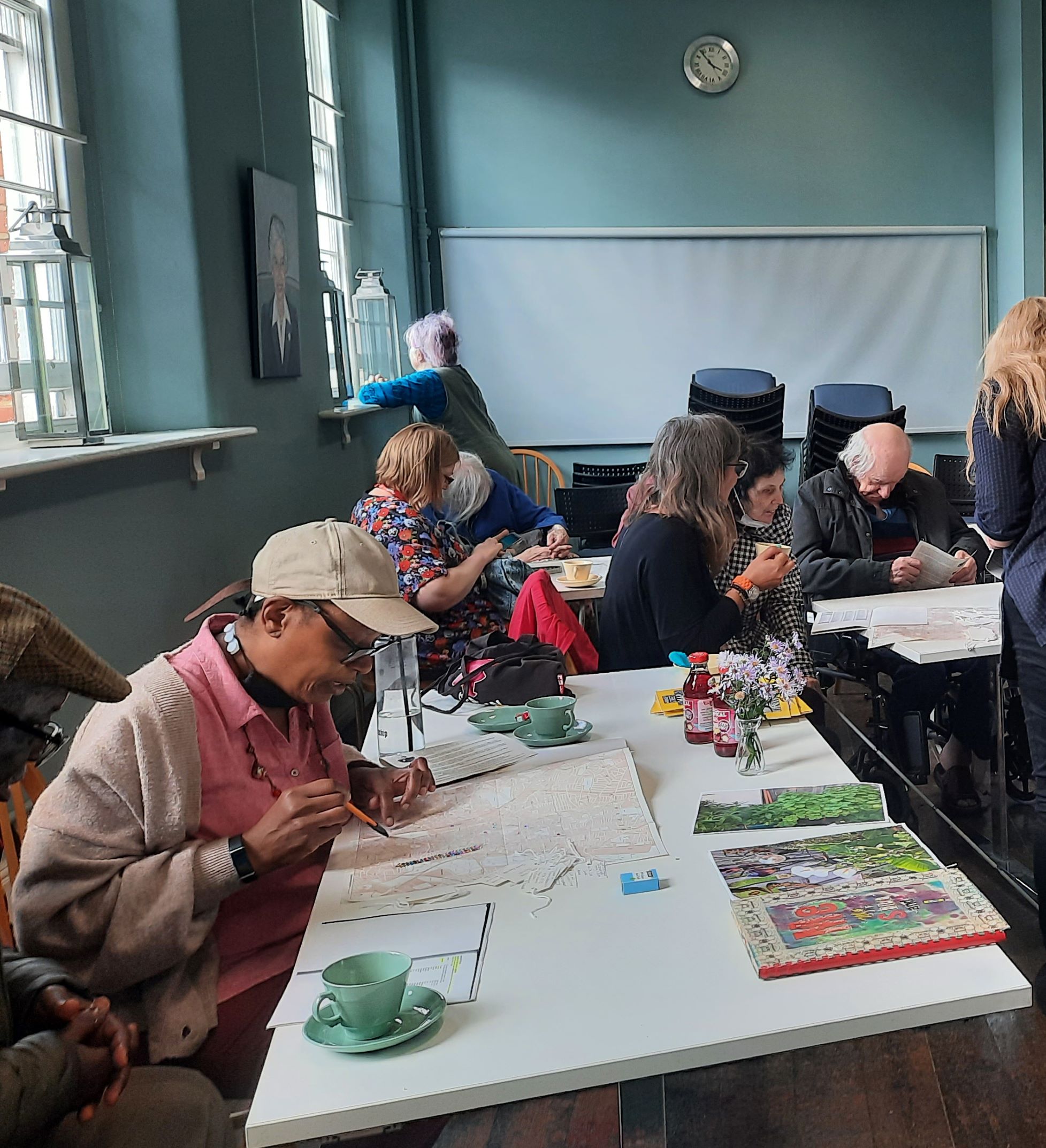Older people sitting at tables looking at records
