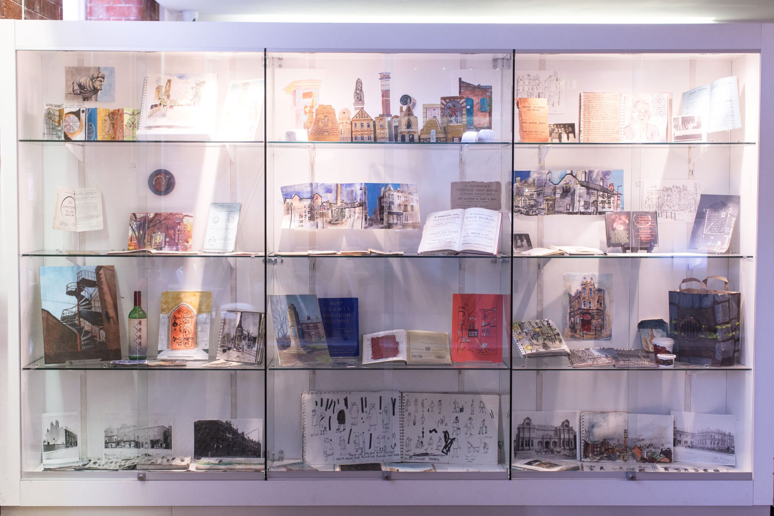 A display of archival documents and paintings in response