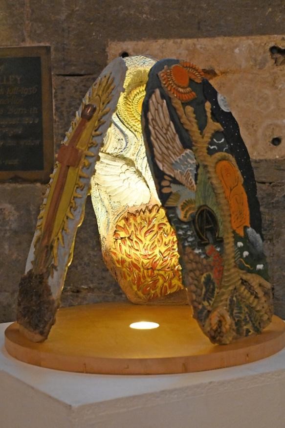 Exhibit titled 'Trinity' crafted by a student from Hereford College of Arts and inspired by Hereford Cathedral, displayed within the cathedral's crypt