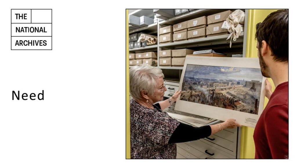 White presentation slide, with 'Need' typed in black on the left of the page, halfway down. The National Archives logo is top left. On the right, just over half of the slide is taken up with an image of two people in an archive storage space, looking at a landscape artwork