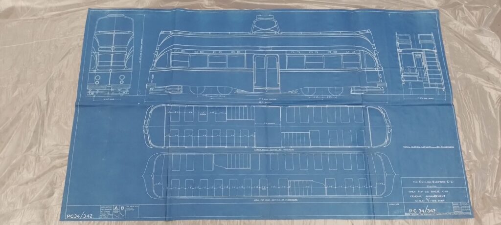 A technical blueprint of a carriage laid out on a clear plastic sheet.