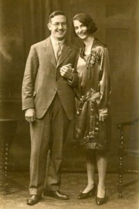 A sepia photo of (left) Benjamin Gates and (right) Doris West, on their wedding day in 1929. Benjamin is wearing a suit and eyeglasses, while Doris wears a dress.