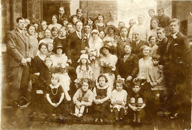 A sepia photo of a large wedding party, after the marriage of Albert Braithwaite to Mary Hickling, 1925.