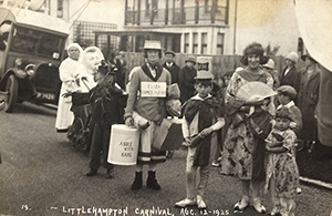 Two mothers pose at Littlehampton Carnival with their children, two boys and a girl. Image taken on 12 August 1925.