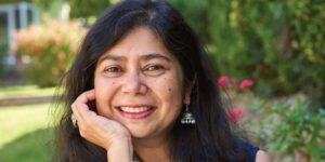 A headshot of Shrabani Basu, with a garden backdrop.