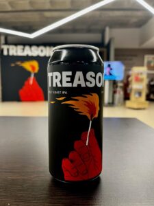 Photograph of Treason IPA can in front of Treason exhibition entrance