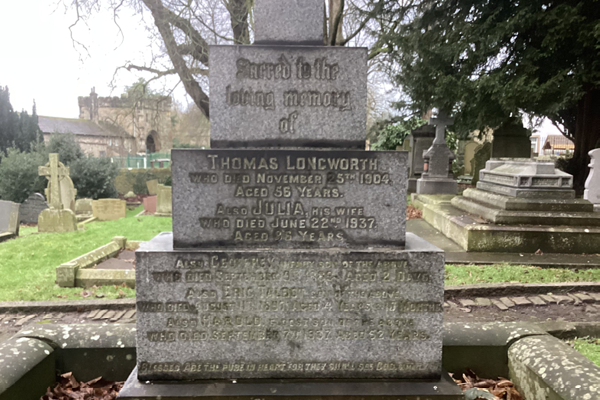 A photograph of a grave, the gravestone reads 'In loving memory of Thomas Longworth who died November 5th 1904 aged 55 years. Also Julia, his wife, who died June 22nd, 1937 aged 36 years."