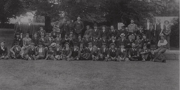 A large group photograph of the brickworkers of Burlesdon Brick Company on a lawn somewhere, clearly on a summer outing