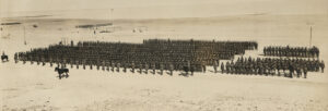 Black and white photograph of army troops assembling in the desert