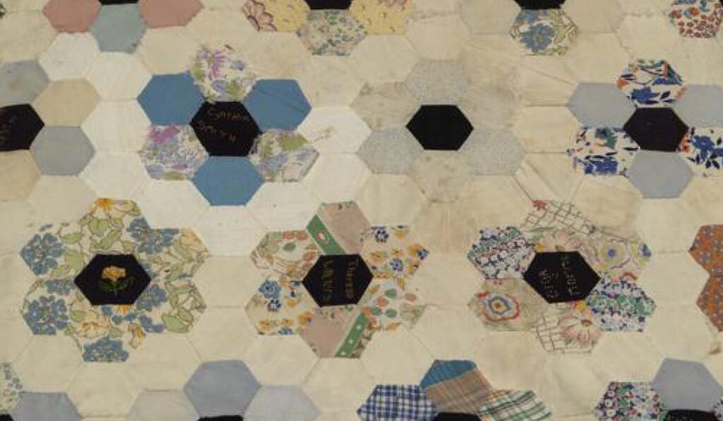 A zoomed in detail of a quilt showing the hexagonal pattern