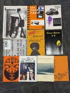 Several colourful posters and journals resting on a surface