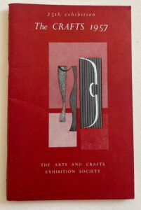 The red front covers of the 1957 Arts & Crafts Exhibition Society Catalogue. 