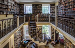 A wide shot of the spiral staircase, gallery and book shelves in Bromley House.