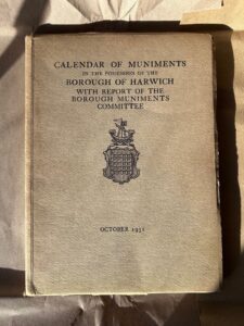 A close-up of a tanned publication entitled 'Calendar of Muniments'.